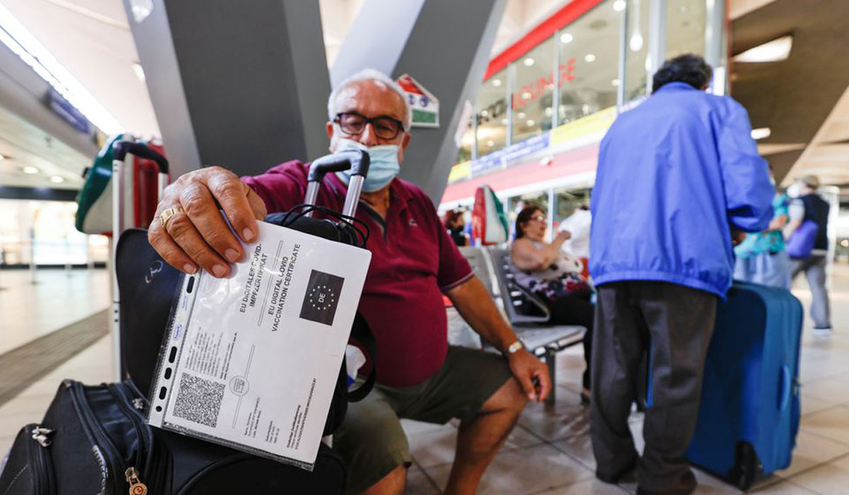 A man shows his COVID-19 certificate